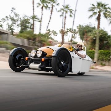 A person driving a morgan super 3
